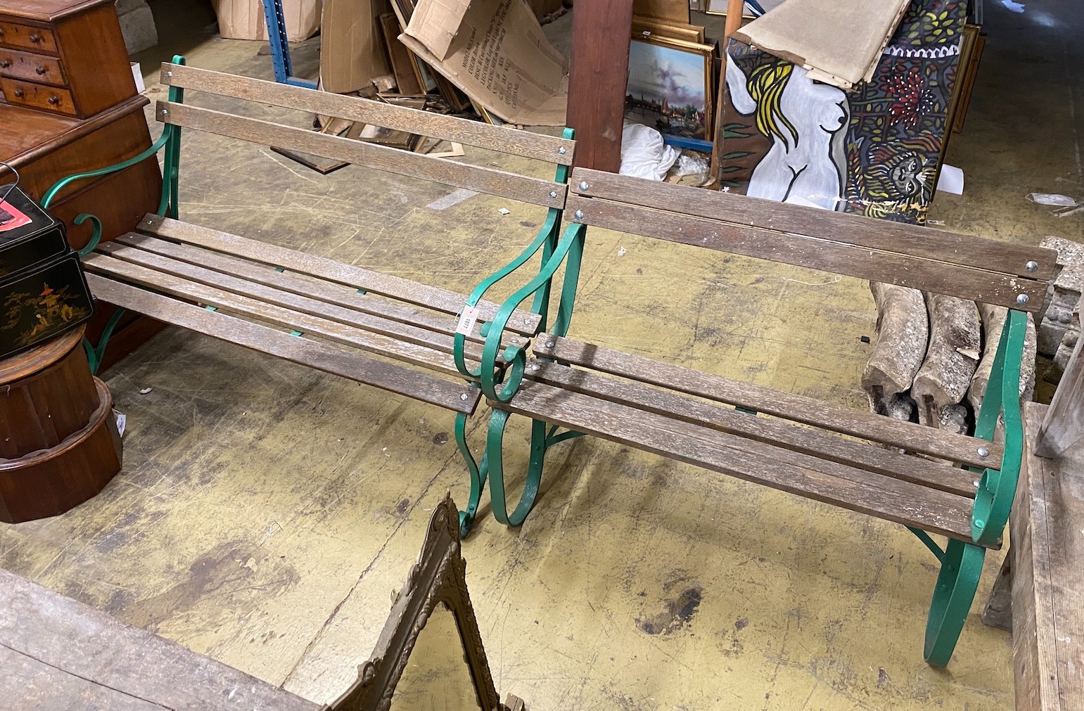 A near pair of painted wrought iron slatted wooden garden benches, larger length 137cm, depth 74cm, height 88cm